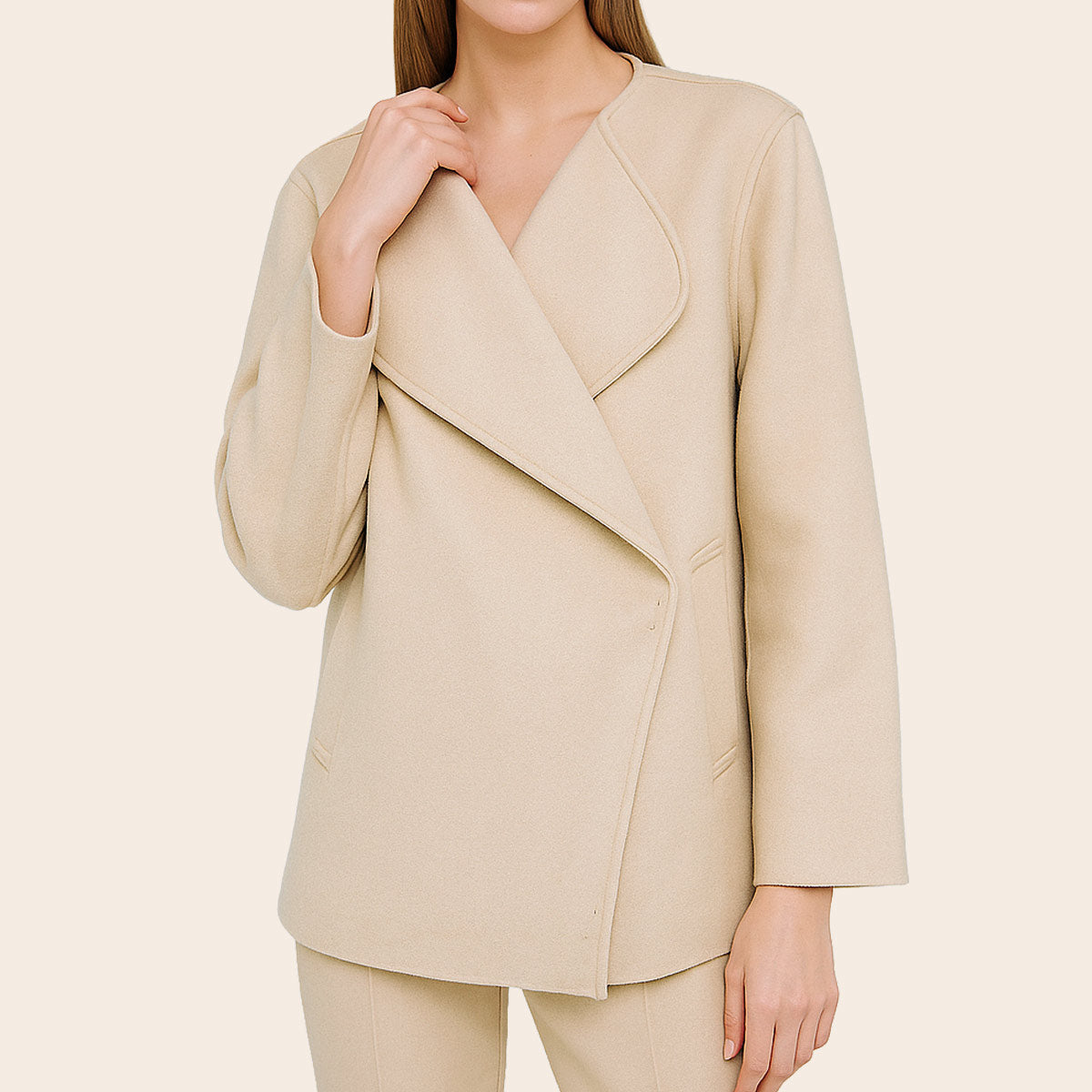 Beige blazer worn by a person on a beige background